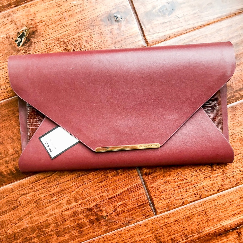 NWT BCBG clutch in wine.
